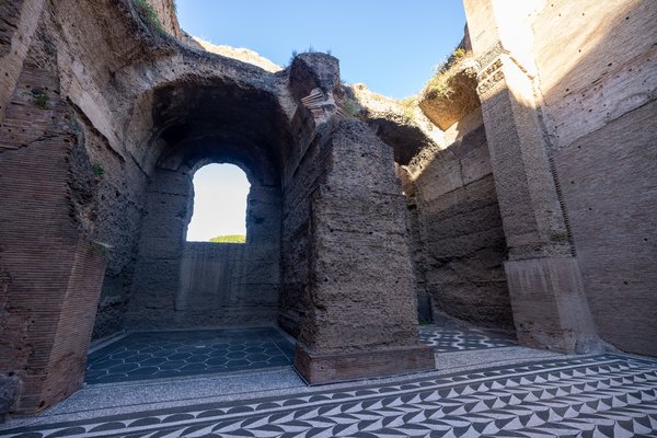 Mosaic floors beneath a vaulted archway