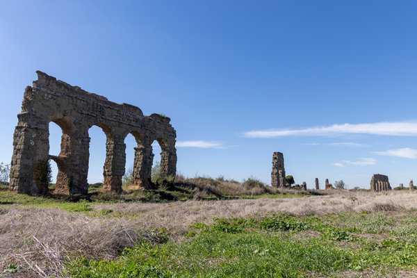 Surviving aqueduct arcade in a Roman field