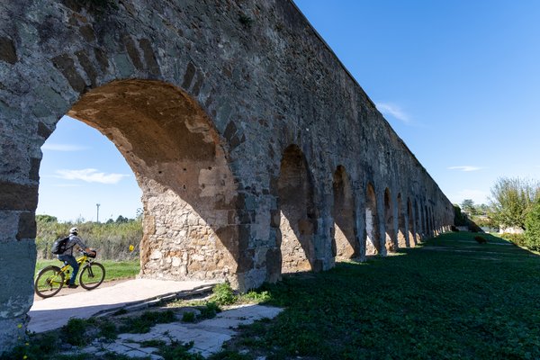 Cyclist beneath the aqueduct arches